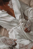 Woman laying down in a satin bridal robe