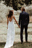 Bride and Groom holding hands in vineyard