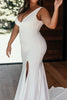 Model wearing the Jones gown and holding white bouquet of flowers